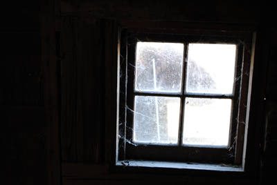 Light coming through a small window high on a coop wall